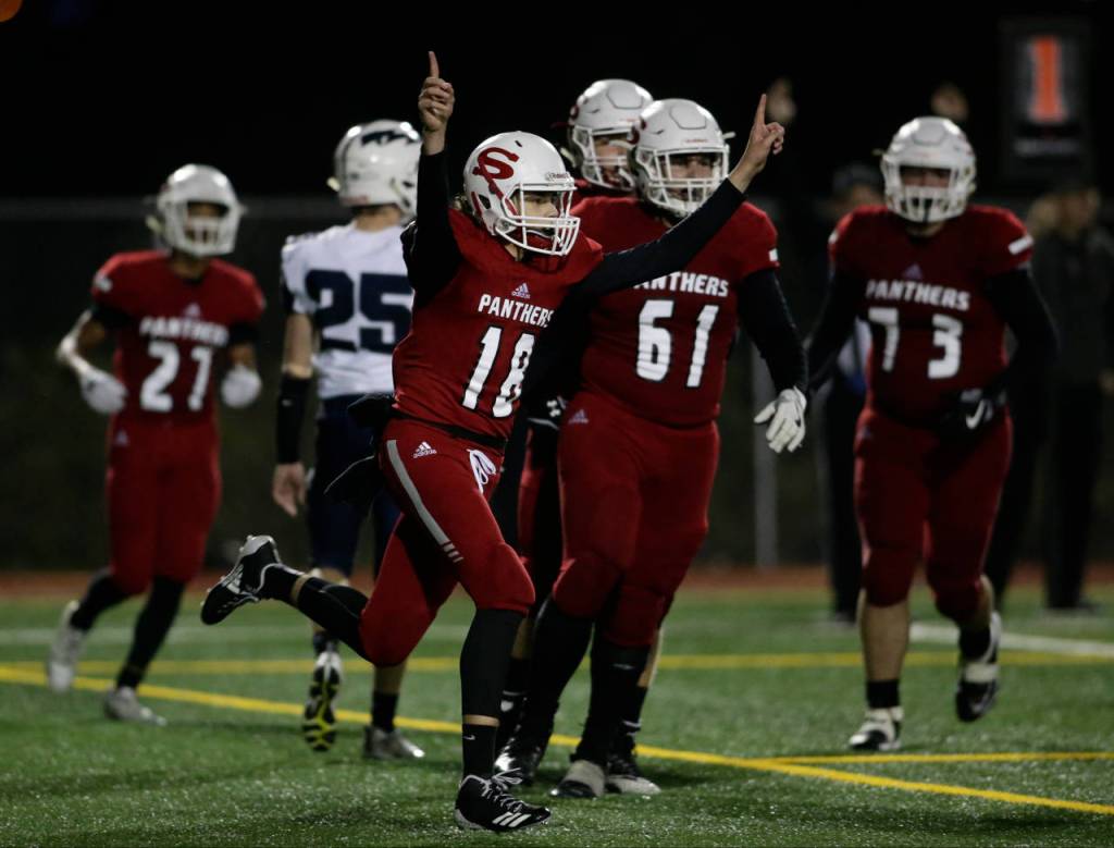 Snohomishs Tayte Conover (18) throws up his arms after scoring on a quarterback keeper during the Panthers 30-27 win over Squalicum on Fridayat Veterans Memorial Stadium in Snohomish. (Andy Bronson / The Herald)