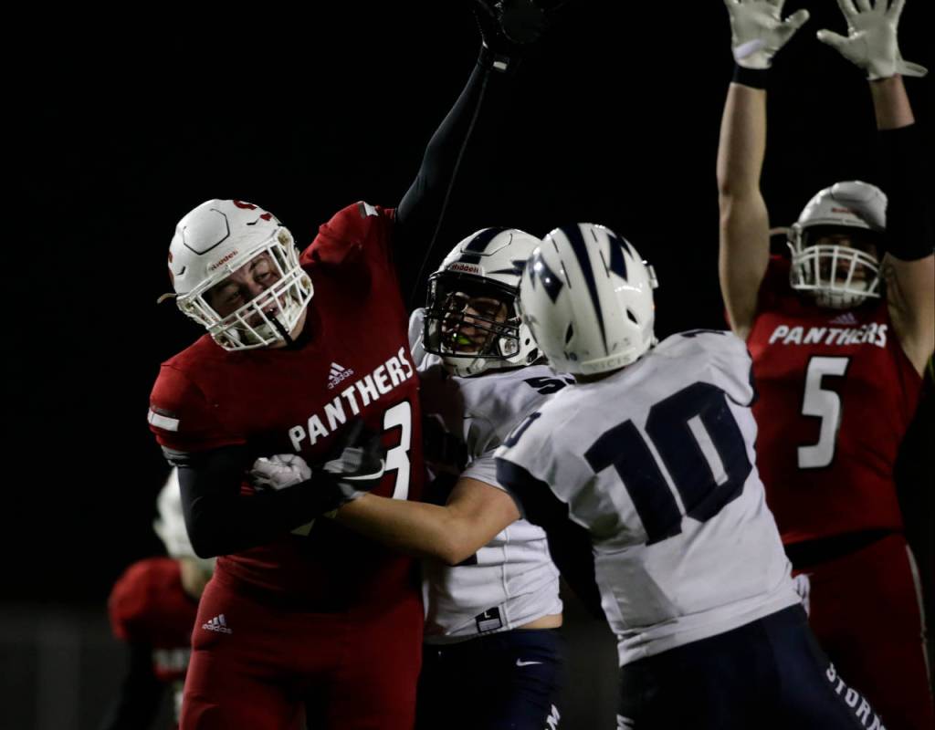 Snohomishs Carter Cole (left) tries to block pass by Squalicums Spencer Lloyd during the Panthers 30-27 win Friday at Veterans Memorial Stadium in Snohomish. (Andy Bronson / The Herald)