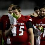 Snohomishs Noah Dunham smells flowers before Senior Night festivities Fridayat Veterans Memorial Stadium in Snohomish. Snohomish beat Squalicum 30-27. (Andy Bronson / The Herald)