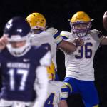 Ferndales Jaden Brown (right) celebrates his fumble return touchdown during a Wesco 3A crossover game against Meadowdale on Friday at Edmonds Stadium. Brown and Golden Eagles beat the Mavericks 56-15. (Kevin Clark / The Herald)