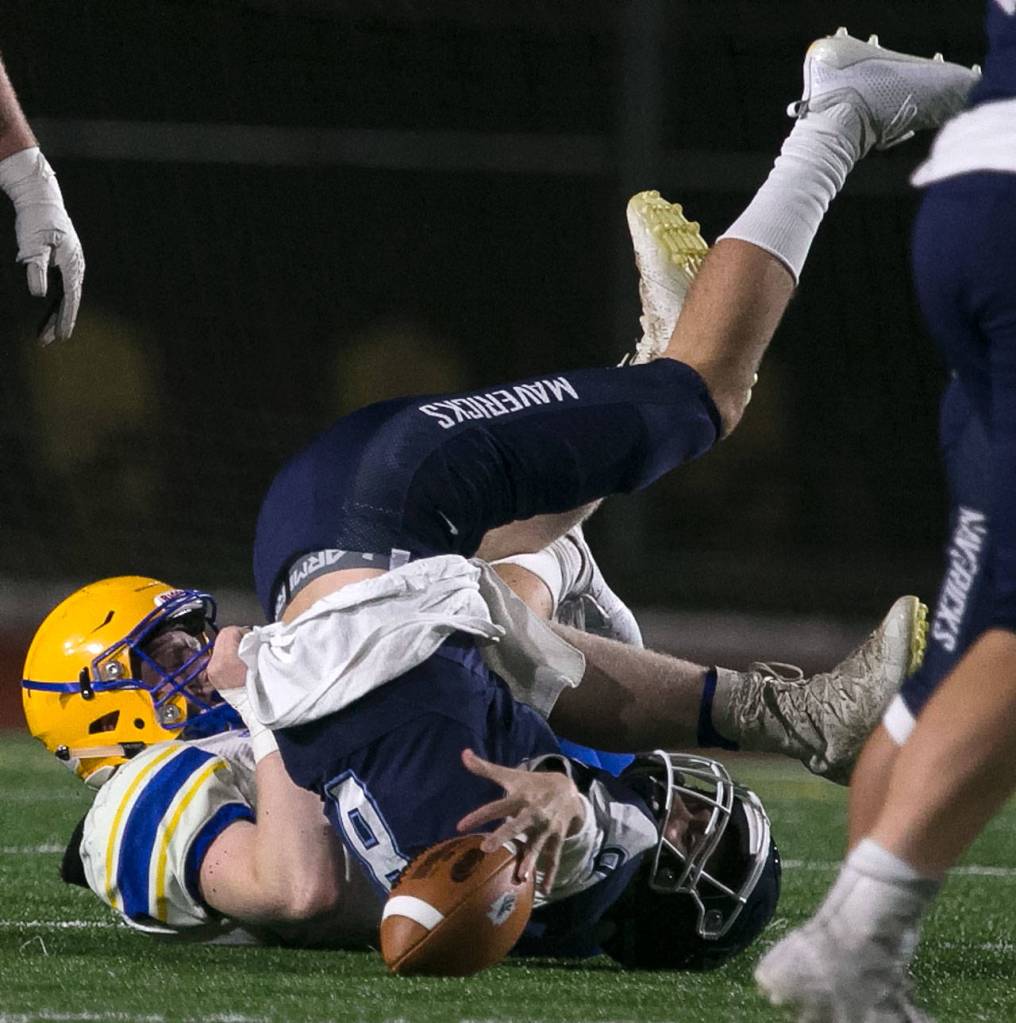 Ferndales Brett Westford sacks Meadowdale quarterback Hunter Moen during a Wesco 3A crossover game Friday at Edmonds Stadium. Westford and the Golden Eagles beat Moen and the Mavericks 56-15. (Kevin Clark / The Herald)