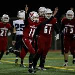 Snohomishs Tayte Conover (18) throws up his arms after scoring on a quarterback keeper during the Panthers 30-27 win over Squalicum on Friday night at Veterans Memorial Stadium in Snohomish. (Andy Bronson / The Herald)