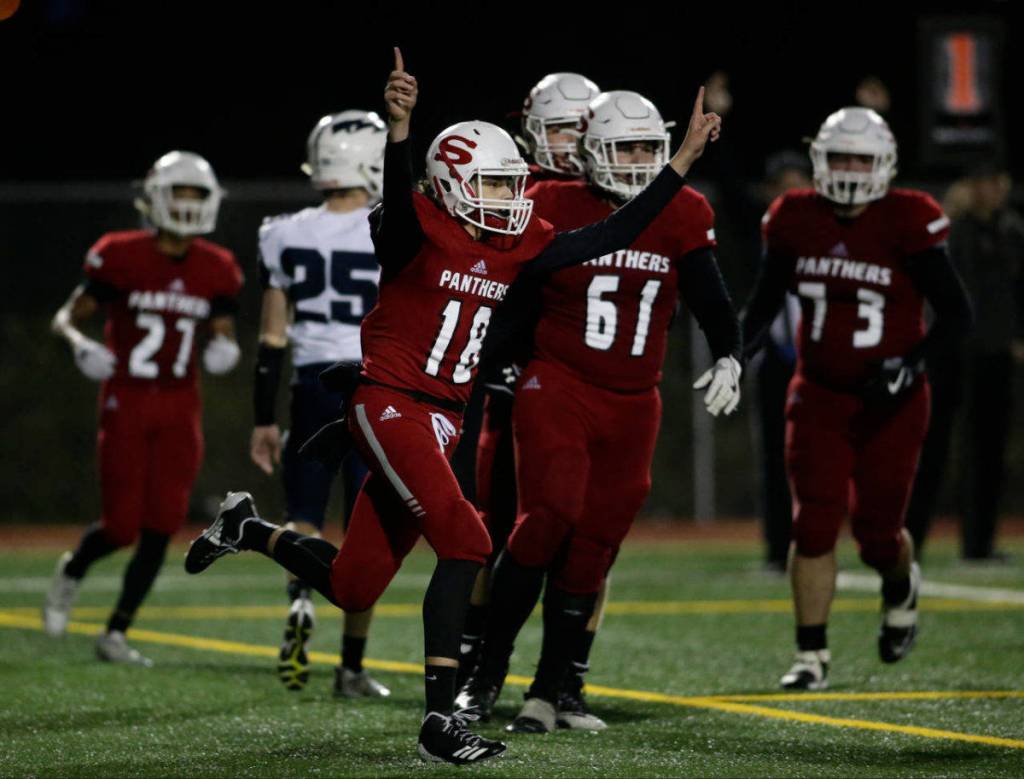 Snohomishs Tayte Conover (18) throws up his arms after scoring on a quarterback keeper during the Panthers 30-27 win over Squalicum on Friday night at Veterans Memorial Stadium in Snohomish. (Andy Bronson / The Herald)