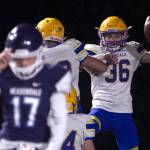 Ferndales Jaden Brown (right) celebrates his fumble-return touchdown during a loser-out Wesco 3A crossover game against Meadowdale on Friday night at Edmonds Stadium. The Golden Eagles eliminated the Mavericks with a 56-15 win. (Kevin Clark / The Herald)