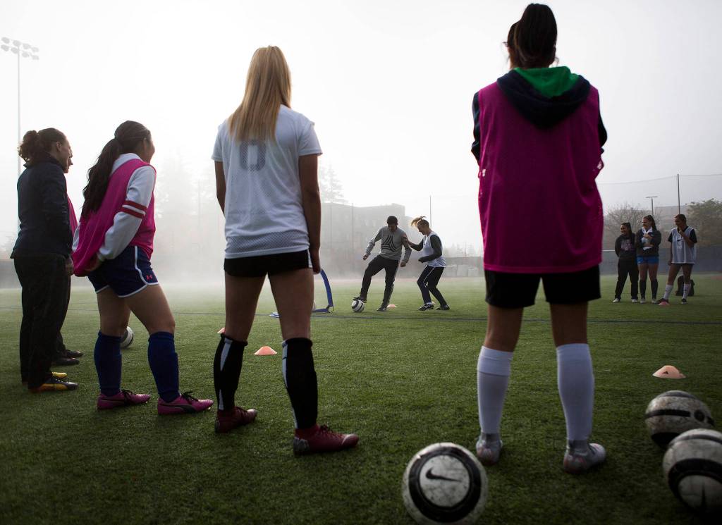 Edmonds Community College midfielder Alex Modica runs through a one vs. one drill against Rafael Spajic during soccer practice at Triton Field on Oct. 19 in Lynnwood. (Olivia Vanni / The Herald)