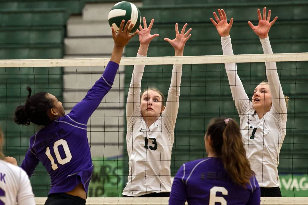 Kamiaks Quinci Flowers (left) attempts a kill with Jacksons Ainsley Johanson (13) and Paige Wilson blocking at Henry M. Jackson High School in Mill Creek on Oct. 23. (Kevin Clark / The Herald)