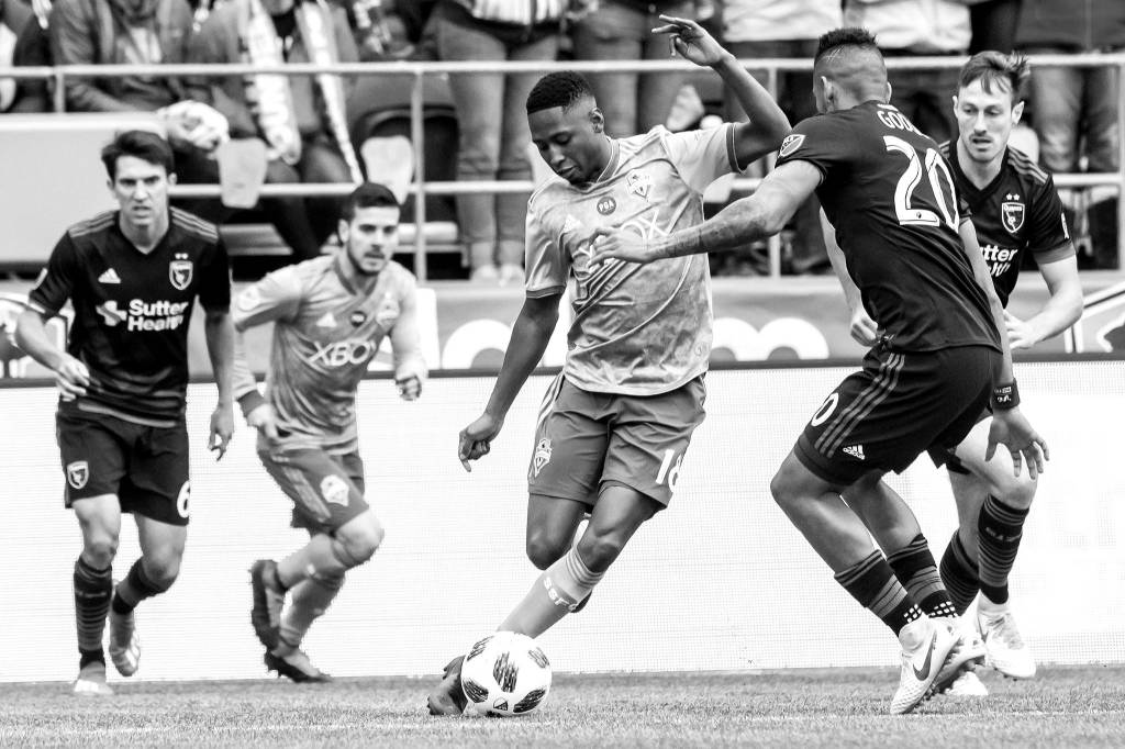 Bettina Hansen / The Seattle Times via AP                                Seattle Sounders defender Kelvin Leerdam (center) maneuvers around San Jose Earthquakes midfielder Anibal Godoy in the first half of an MLS soccer game Sunday in Seattle.