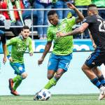 Seattle Sounders defender Kelvin Leerdam (center) maneuvers around San Jose Earthquakes midfielder Anibal Godoy in the first half of an MLS soccer game Sunday in Seattle. (Bettina Hansen/The Seattle Times via AP)