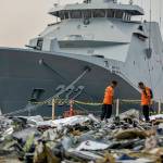 Members of National Search and Rescue Agency inspect debris retrieved from the waters where Lion Air flight JT 610 is believed to have crashed, at Tanjung Priok Port in Jakarta, Indonesia, on Wednesday. (AP Photo/Fauzy Chaniago)