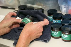 Ron Gordon sells the CBD balm that he makes at the Snohomish Senior Center. (Lizz Giordano / The Herald)