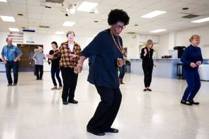 Diane Flagg twists during a line dance class at the Edmonds Senior Center on Monday, Oct. 29, 2018 in Edmonds, Wa. Flagg, 71, who lost her husband two years ago, dances five times a week. (Andy Bronson / The Herald)                                Diane Flagg twists during a line dance class at the Edmonds Senior Center on Monday, Oct. 29, 2018 in Edmonds, Wa. Flagg, 71, who lost her husband two years ago, dances five times a week. (Andy Bronson / The Herald)