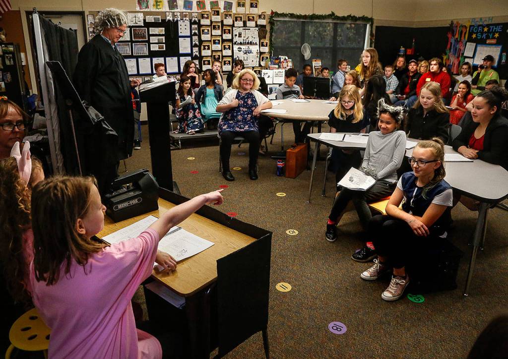 Sitting in the witness box with first little pig Burgendey Poole to her left, second little pig Caroline Zurybida points straight at the suspect on trial. (Dan Bates / The Herald)