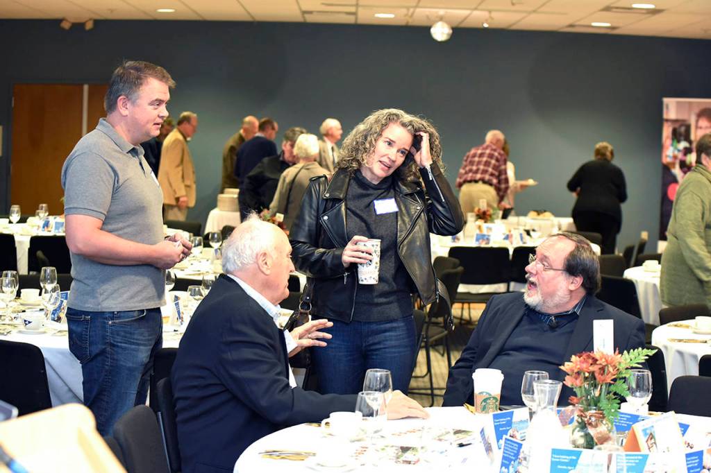 Jack Faris (seated left) and John Medina (seated right) visit with Tom Sanger and Beth Sanger at an Oct. 25 fundraising breakfast for the Edmonds Senior Centers capital campaign. (Contributed photo)