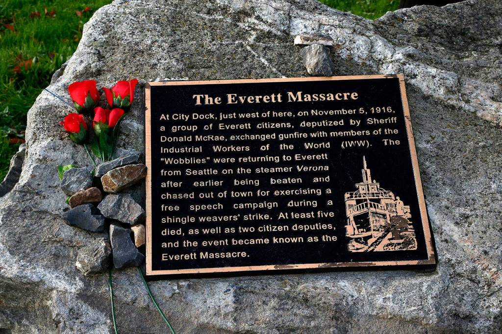 A visitor at the Everett Massacre memorial left roses. Dan Bates / The Herald