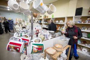 Nancy Hills, of Bonney Lake, looks over bottles at the Good Cheer Thrift Store on Friday, Nov. 9, 2018 in Langley, Wa. There are two on the island that fund 80 percent of the revenue for the food bank. The store in downtown Langley is a popular stop for tourists and islanders. (Andy Bronson / The Herald)