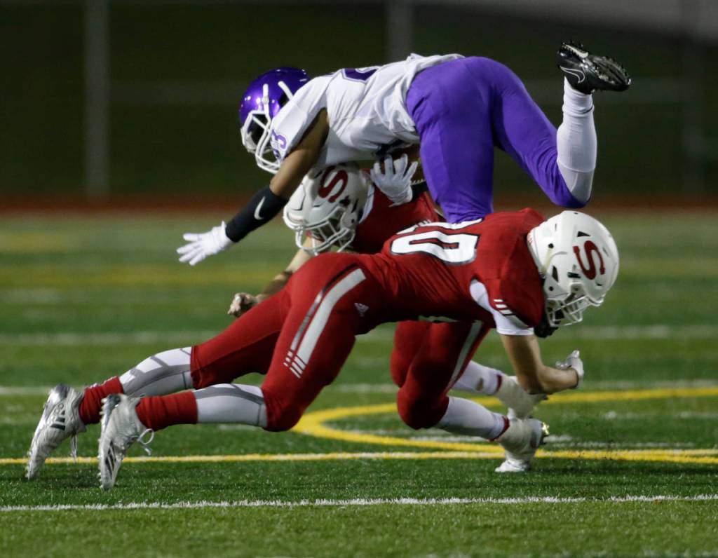 Snohomishs Caden Keithley (front) upends Garfields Isaiah Kenard (10) during a Week 10 playoff game on Nov. 2, 2018, at Veterans Memorial Stadium in Snohomish. Snohomish won 42-35. (Andy Bronson / The Herald)