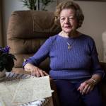 Elaine Reas, 87, with a handful of 100-year-old letters written by her father during World War I, at her home in Lynnwood on Friday. (Olivia Vanni / The Herald)