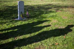 Family members of Civil War veteran John Louis Grant stand next to his tombstone before the tombstone dedication ceremony on Veterans Day on Sunday in Arlington. (Olivia Vanni / The Herald)