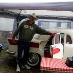 John Norris stands beside Miss Piggy, a camping trailer built from many spare parts of cars, trucks and motorcycles. It was assembled by Brian Woods of British Columbia. (Patricia Guthrie/Whidbey News Group)