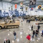 Visitors admire the tanks and planes in the new 30,000-square-foot hangar at the Flying Heritage & Combat Armor Museum at Paine Field on Saturday, Nov. 10, 2018 in Everett. (Andy Bronson / The Herald)
