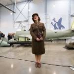 Marie Samson, of Redmond, poses for pictures in her World War II uniform in front of a Junkers Ju-87 Stuka in the new 30,000 foot hangar at the Flying Heritage & Combat Armor Museum at Paine Field on Saturday, Nov. 10, 2018 in Everett, Wa. (Andy Bronson / The Herald)