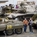 Visitors talk between a half-dozen tanks in the new hangar at the Flying Heritage & Combat Armor Museum at Paine Field on Saturday, Nov. 10, 2018 in Everett. (Andy Bronson / The Herald)