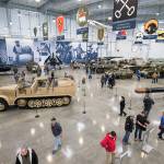Visitors admire the tanks and planes in the new 30,000-square-foot hangar at the Flying Heritage & Combat Armor Museum at Paine Field on Saturday, Nov. 10, 2018, in Everett. (Andy Bronson / The Herald)