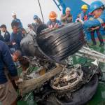 Rescuers inspect part of a landing gear of a crashed Lion Air Boeing 737-800 MAX, which they retrieved from the sea floor in the waters of Tanjung Karawang, Indonesia, on Sunday. (AP Photo/Fauzy Chaniago)