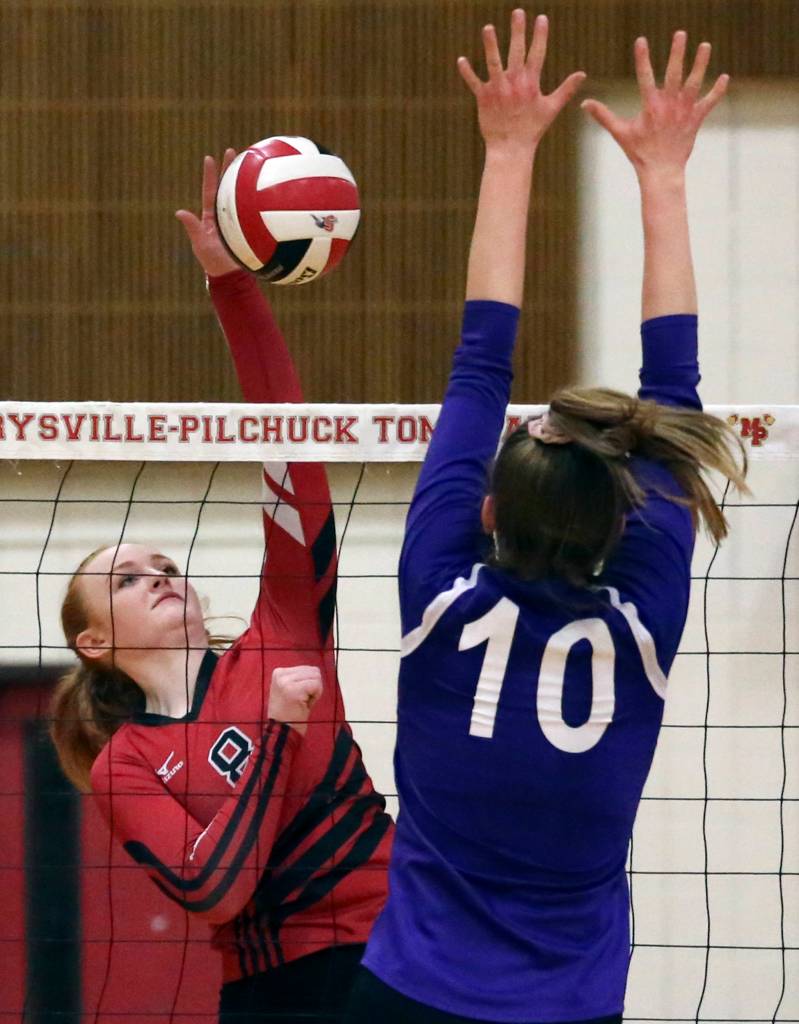 Snohomishs Grace Raper (left) spikes against Oak Harbors Morgan Pease at Marysville Pilchuck High School on Nov. 8. Snohomish won in straight sets. (Kevin Clark / The Herald)