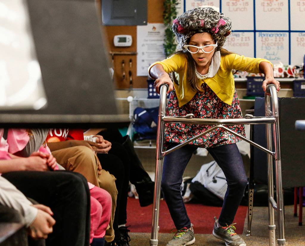 After testifying, Granny Wolf, played by Eden Young, struggles through the crowded courtroom to get back to her seat. Her class staged a mock trial, <a href="https://www.heraldnet.com/news/wolf-found-guilty-as-kids-learn-and-a-federal-judge-laughs/" target="_blank">State of Washington v. Sneezy the Wolf,</a> in front of a real federal judge. (Dan Bates / The Herald)