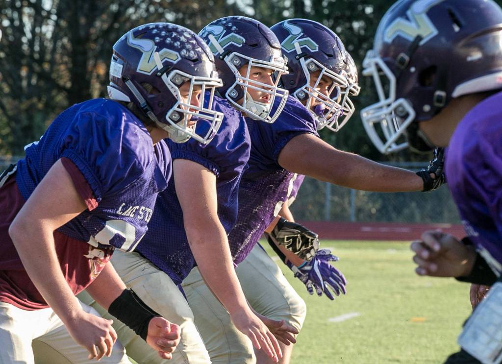 Members of the Lake Stevens High School offensive line come off the line during practice on Nov. 7. (Kevin Clark / The Herald)