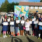 Students and library boosters took part in a ribbon cutting Nov. 10 for the latest signal box wrap, Libraries Are For Everyone!, at the northeast corner of 194th Street and 44th Avenue outside the Lynnwood Police Station. (Contributed photo)