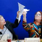 Canvassing Board chair Judge Betsy Benson (left) and board member Judge Deborah Carpenter-Toye (right) show political lawyers one of the ballots that was damaged during the recount that will need to be duplicated and then recounted, at the Broward County Supervisor of Elections office during a recount Wednesday in Lauderhill, Florida. (AP Photo/Wilfredo Lee)