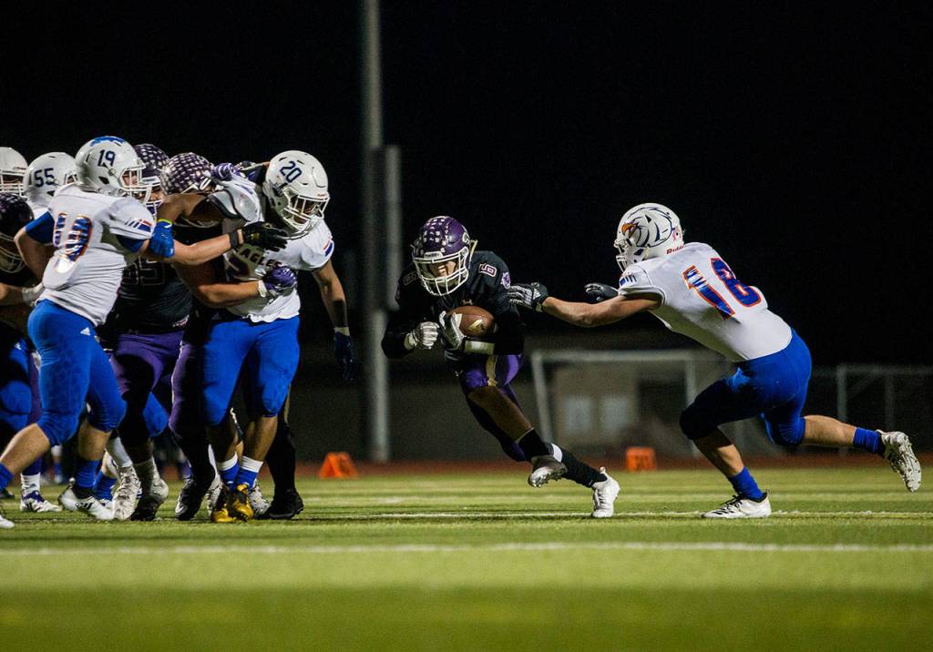 Lake Stevens Dallas Landeros runs the ball through a hole in the defense during a 4A state quarterfinal game against Graham-Kapowsin on Nov. 17, 2018, in Lake Stevens. (Olivia Vanni / The Herald)