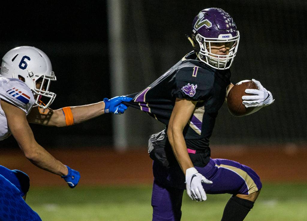 Lake Stevens Ian Hanson runs the ball into the end zone while his jersey is pulled during the game against Graham Kapowsin on Saturday, Nov. 17, 2018 in Everett, Wa. (Olivia Vanni / The Herald)