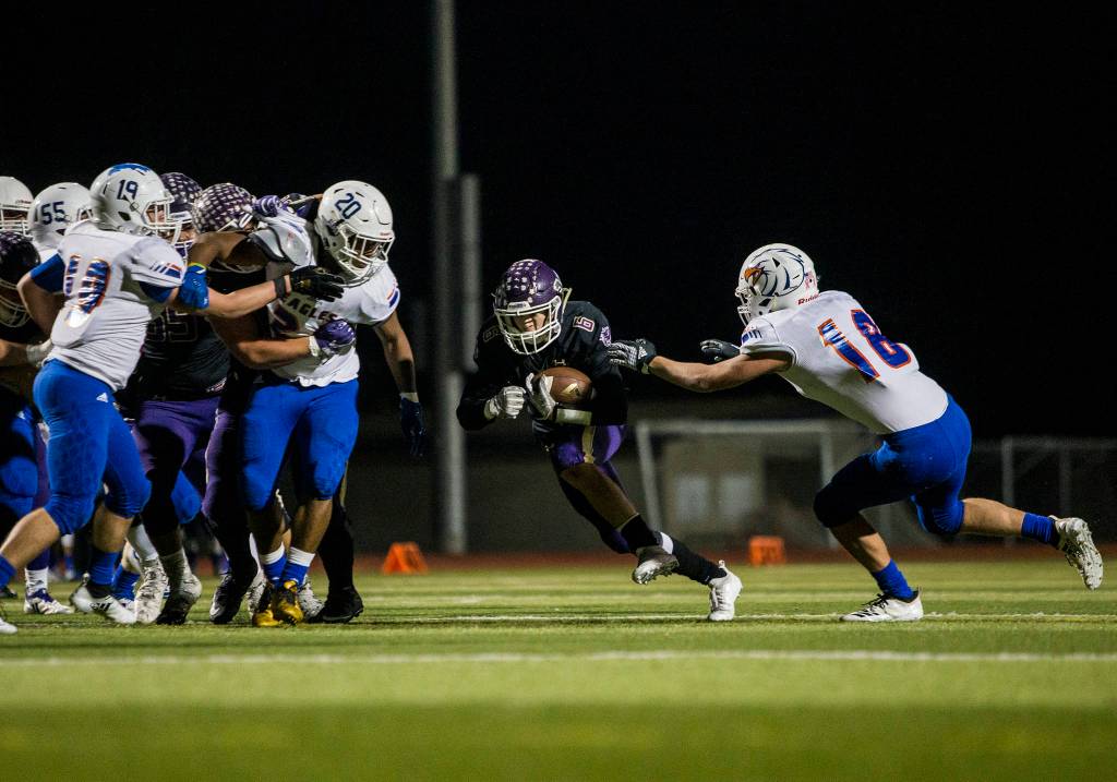 Lake Stevens Dallas Landeros runs the ball through a hole in the opposing teams defense during the game against Graham Kapowsin on Saturday, Nov. 17, 2018 in Everett, Wa. (Olivia Vanni / The Herald)