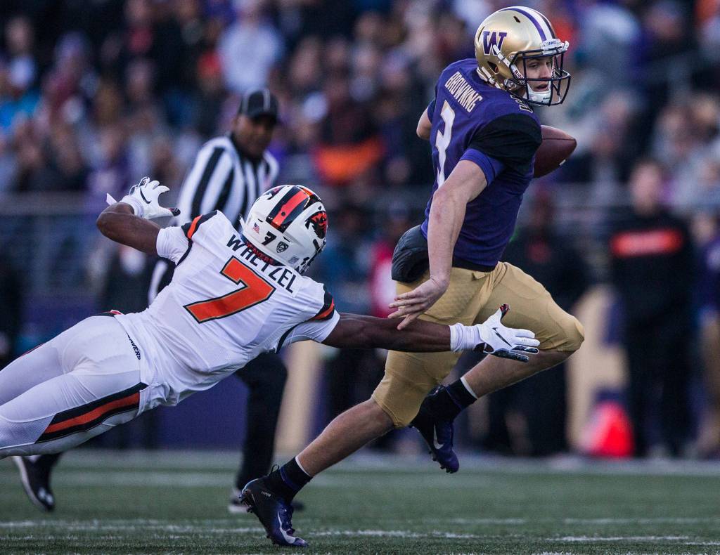 Washingtons Jake Browning escapes a tackle by Oregon States Kee Whetzel during the game against Oregon State on Saturday, Nov. 17, 2018 in Seattle, Wa. (Olivia Vanni / The Herald)