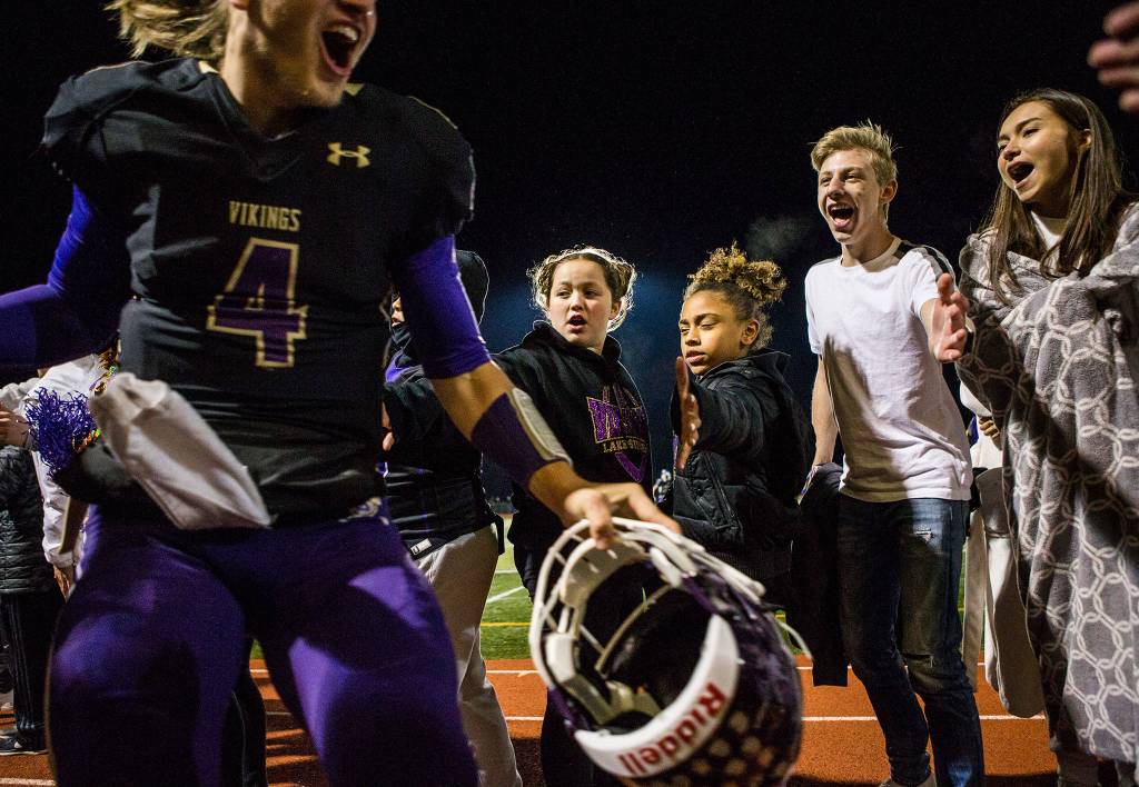 Lake Stevens Tre Long high-fives fans after the game against Graham Kapowsin on Saturday, Nov. 17, 2018 in Lake Stevens, Wa. (Olivia Vanni / The Herald)