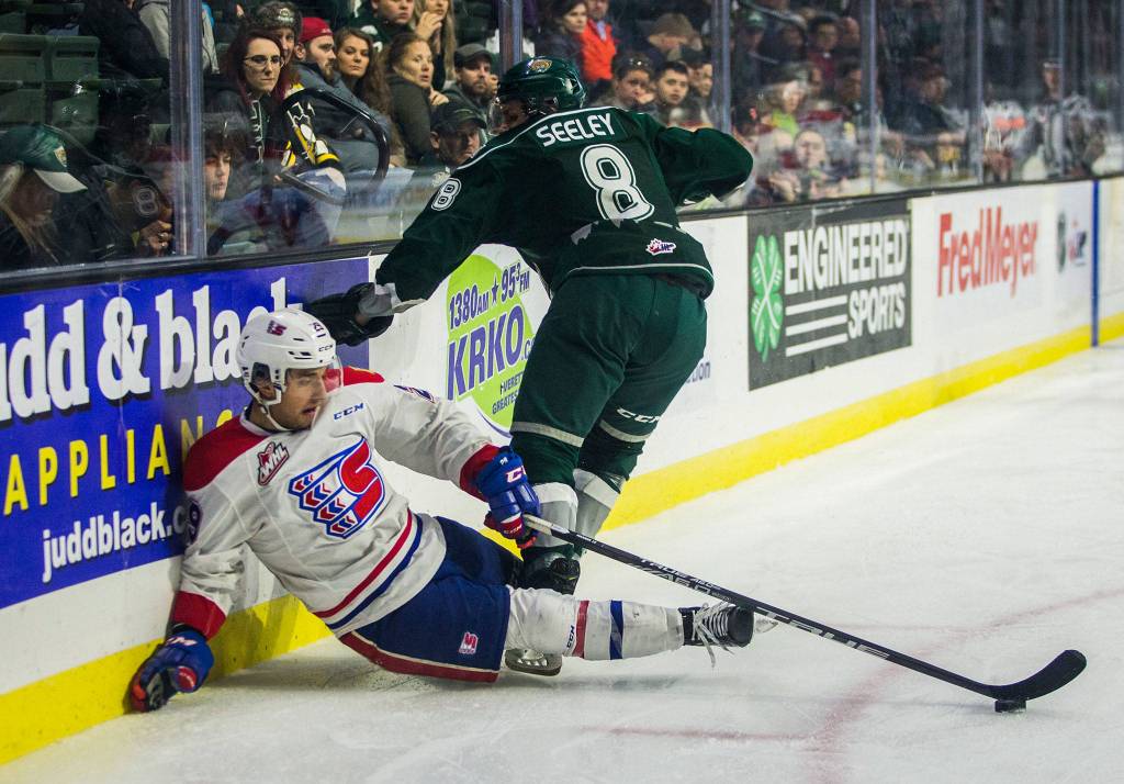 Silvertips Ronan Seeley knocks Spokanes Eli Zummack into the wall during the game against the Spokane Chiefs on Sunday, Nov. 18, 2018 in Everett, Wa. (Olivia Vanni / The Herald)