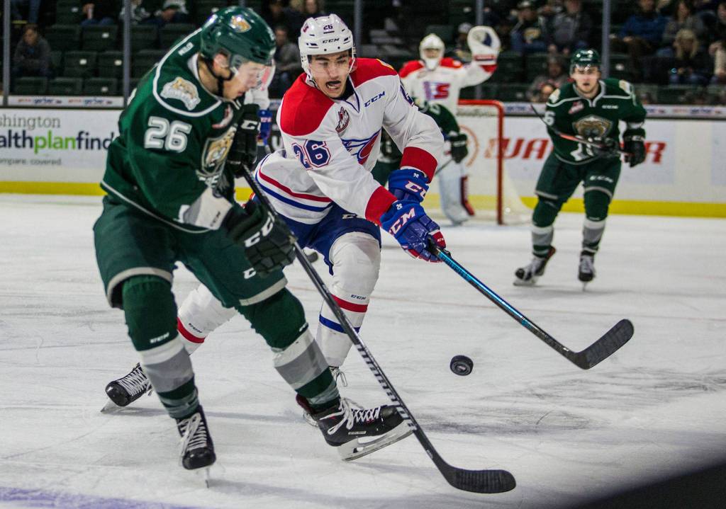 Silvertips Reece Vitelli and Spokanes Jack Finley go after the puck during the game against the Spokane Chiefs on Sunday, Nov. 18, 2018 in Everett, Wa. (Olivia Vanni / The Herald)