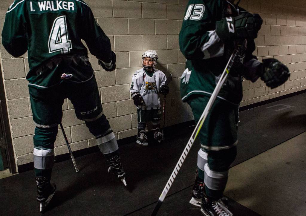 Silvertips Ian Walker fist bumps Karsen Baker, 6, before the game against the Spokane Chiefs on Sunday, Nov. 18, 2018 in Everett, Wa. (Olivia Vanni / The Herald)