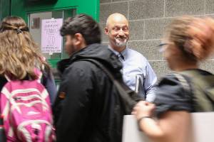 Principal Dave Peters holds the door for students exiting first lunch Monday morning at Henry M. Jackson High School in Mill Creek on Jan. 22. (Kevin Clark / The Daily Herald)