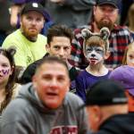 Finn Ottele (center right) and Mady Ottele (left) sport Washington Huskies face paint at Dutch Hill Elementarys Apple Cup-themed Dads n Donuts event, with the gym decked out in Cougar and Husky colors, on Nov. 21, 2018, in Snohomish. (Andy Bronson / The Herald)