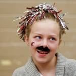Emma Rices mustache shows her support for the Cougars as Dutch Hill Elementary held an Apple Cup-themed Dads n Donuts event, with the gym decked out in Cougar and Husky colors, on Nov. 21, 2018, in Snohomish. (Andy Bronson / The Herald)
