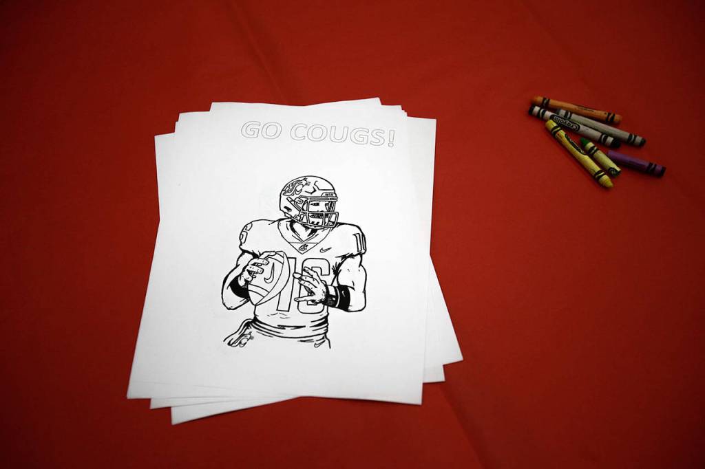 Dutch Hill Elementary held an Apple Cup-themed Dads n Donuts event, with the gym decked out in Cougar and Husky colors, on Nov. 21, 2018, in Snohomish. (Andy Bronson / The Herald)