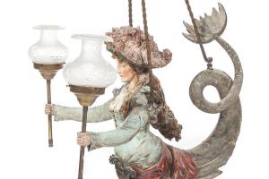 Carved mermaid on hanging lamp fully clothed in 1900s fashion