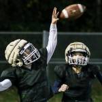Connor Geary attempts a catch with Kaiden Duong trailing during practice at the Lake Stevens Boys and Girls Club on Nov. 15. (Kevin Clark / The Herald)