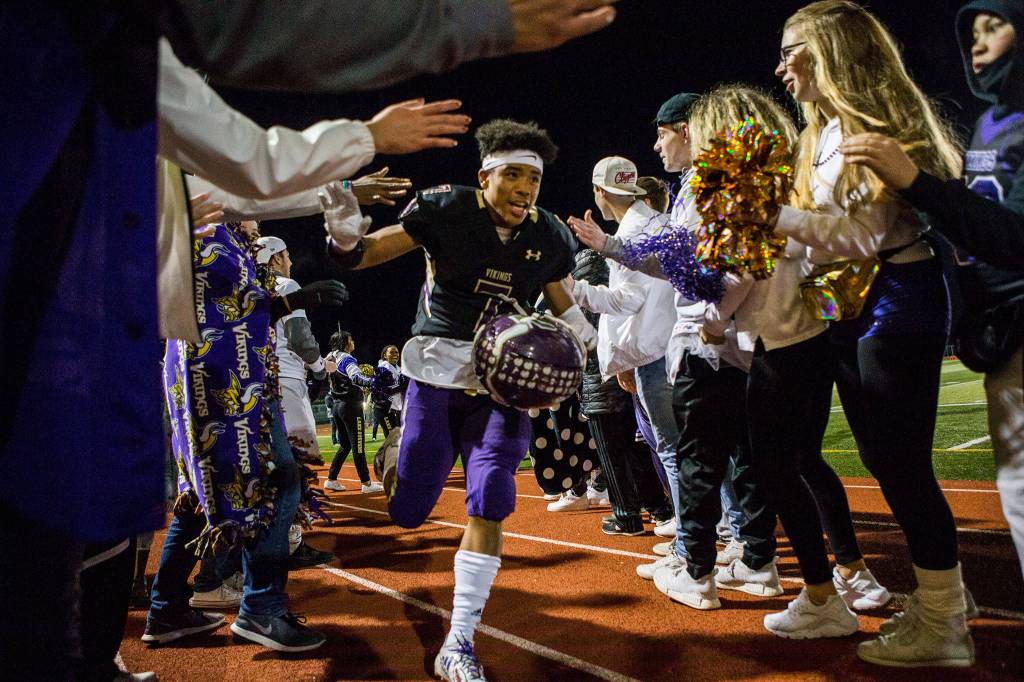 Lake Stevens Isaiah Harris high-fives fans after the game against Graham Kapowsin on Nov. 17 in Everett. Photo gallery <a href="https://www.heraldnet.com/sports/gallery-lake-stevens-beats-graham-kapowsin-in-state-quarterfinal/" target="_blank">here</a>. (Olivia Vanni / The Herald)