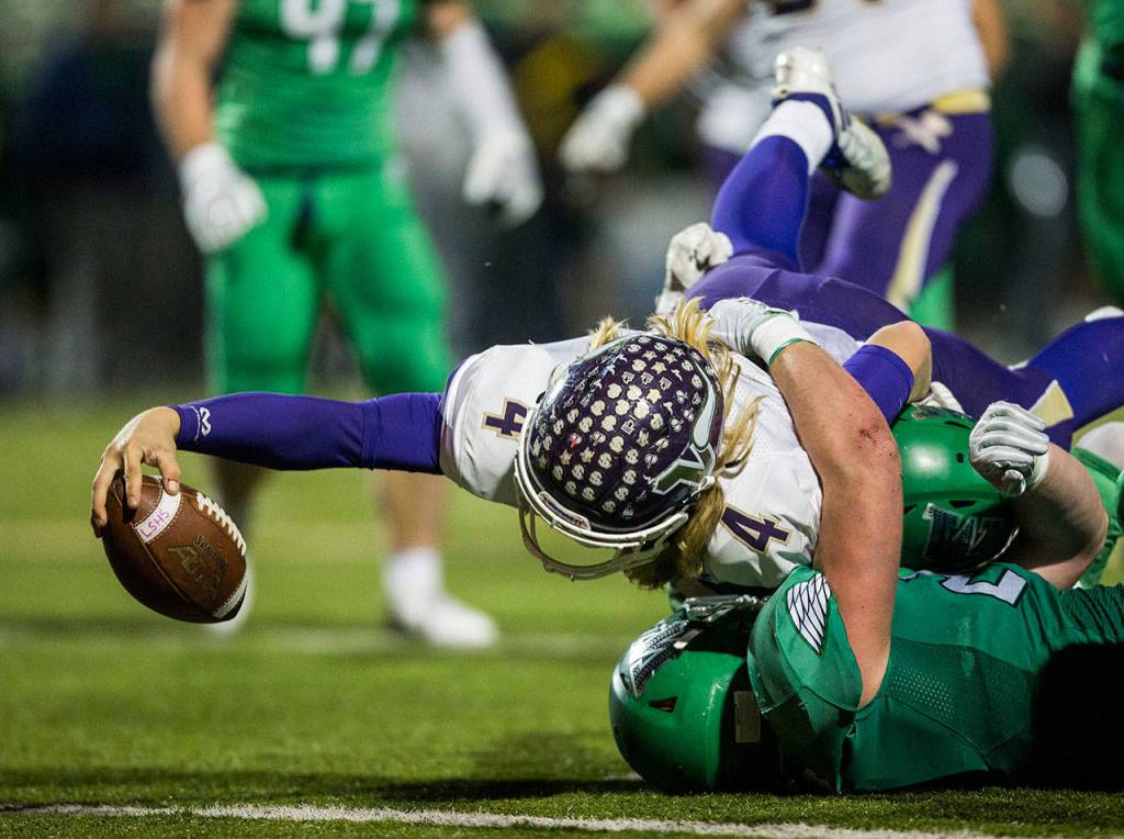 Lake Stevens Tre Long reaches across the goal line for a touchdown during a 4A state state semifinal game against Woodinville on Nov. 24, 2018, at Pop Keeney Stadium in Bothell, Wa. (Olivia Vanni / The Herald)