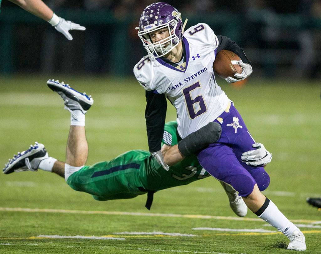Lake Stevens Dallas Landeros runs through a tackle during a 4A state state semifinal game against Woodinville on nov. 24, 2018, at Pop Keeney Stadium in Bothell. (Olivia Vanni / The Herald)